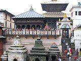 Kathmandu Pashupatinath 01 Pashupatinath Temple From Across Bagmati River The Pashupatinath Temple complex in Kathmandu on the banks of the holy Bagmati River is Nepal�s most important Hindu temple, and probably the holiest Hindu site outside India. Pashupati is one of the many names of Shiva, the most revered god in the Hindu pantheon, this one meaning the Lord of the Animals. Supposedly Shiva needed a holiday from Mount Kailash and chose the Kathmandu valley. Non-Hindus are not allowed to enter the temple. Below the Pashupatinath temple runs the Bagmati River, a holy river that eventually joins the Ganges. Pilgrims throw the holy water onto themselves, while a few hearty Hindus bathe fully.